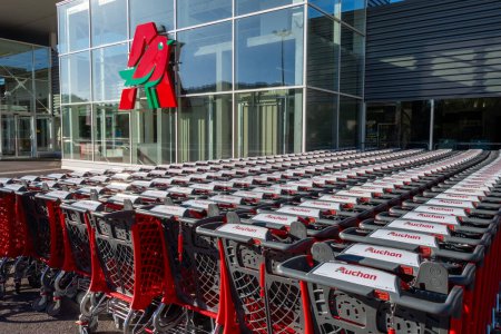 Photo for Gap, France - August 6, 2023: Rows of many branded shopping carts outside an Auchan supermarket. Auchan is a French company and a multinational retail group - Royalty Free Image