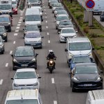 Paris, France - February 23, 2024: A motorcycle travels between two lines of cars on the Paris boulevard Peripherique ring road. Inter-line circulation of motorcycles is being tested in France