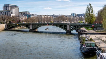 Distant view of the Sully bridge. The Sully bridge (aka Pont de Sully) is a metal arch bridge crossing the Seine in Paris, France