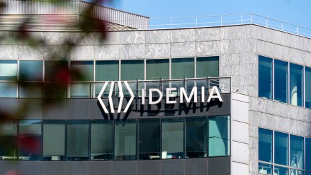 Photo for Courbevoie, France - May 9, 2024: Sign and logo on the headquarters building of Idemia, a French digital security company specializing in biometrics, identification, authentication and AI - Royalty Free Image