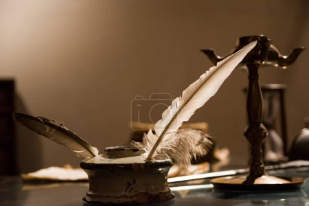 Photo for Ancient inkwell with an original bird pen - Royalty Free Image