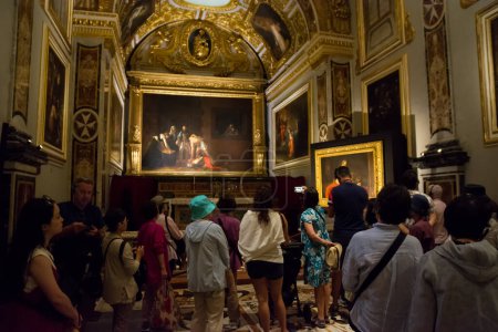 Photo for Valletta, Malta - 17 June 2023: Tourists in the sacristy room inside the Valletta co-cathedral in Malta where the two paintings by Caravaggio are exhibited: the beheading of Saint John the Baptist and Saint Jerome writing - Royalty Free Image