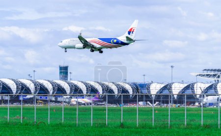 Photo for Samut Prakan, Thailand: September 16,  2023: Commercial aircraft Malaysia airline is landing at Suvarnabhumi International Airport with blue sky.- editorial - Royalty Free Image