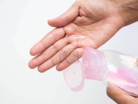 Baby Oil on Palm on White Background,Woman Pour Massage on Hand for Apply Body and Face after Shower in Bathroom at Home for Nourishes Skin to be Soft and Moisturized,Cosmetic for Beauty and Health.