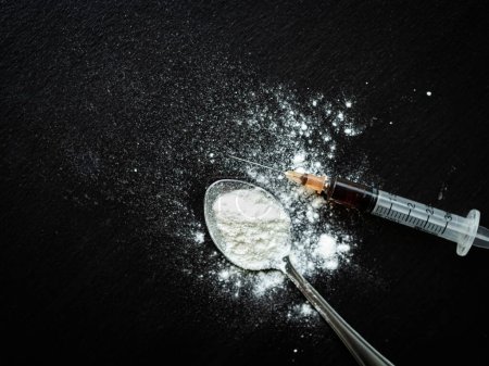 Heroin Drug Needle in Syringe with Powder Addict Abuse on Spoon with Black Wood Background,Illegal Narcotic Medical,Concept for Crime,Health Medicine Overdose Science Treatment ,Death,Cocaine.