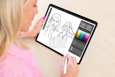 Photo for Woman drawing sketches with pencil on digital tablet computer - Royalty Free Image