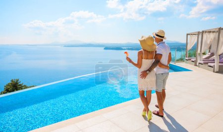 Photo for Wealthy couple enjoying beautiful sea view of luxury Mediterranean villa - Royalty Free Image