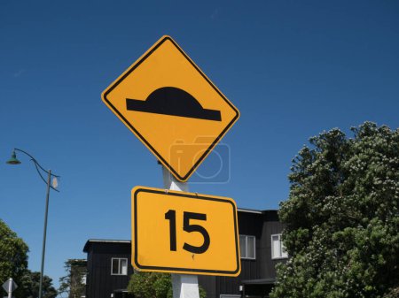 Photo for Yellow road signs indicate that speed humps are in the road and suggested maximum speed is 15 kph.Yellow road signage.Warning - Royalty Free Image