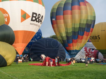 Photo for Bristol-UK-August 11 ,2023 - At Bristol Balloon Fiesta many hot air balloons are seen being inflated. - Royalty Free Image