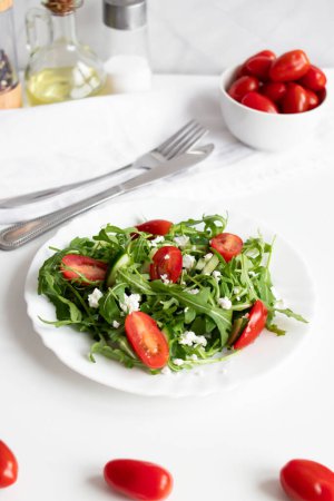 Green vegan salad with arugula leaves and cherry tomatoes. Snack, food