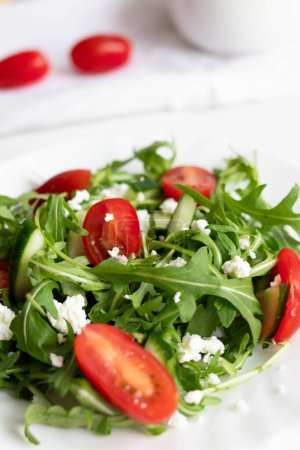 Photo for Green vegan salad with arugula leaves and cherry tomatoes. Snack, food - Royalty Free Image