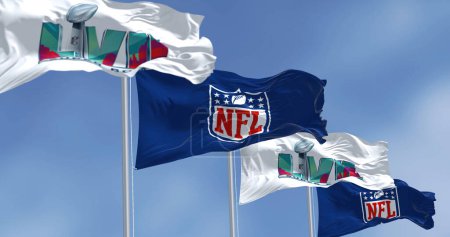 Photo for Glendale, US, Nov 2022: Flags of he 57th Super Bowl and NFL waving in the wind. The game is scheduled to be played on February 12, 2023 in Glendale, Arizona - Royalty Free Image