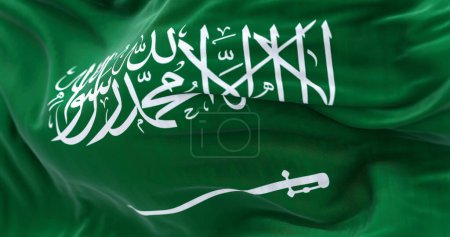 Téléchargez les photos : Vue rapprochée du drapeau national de l'Arabie saoudite agitant le vent. Le Royaume d'Arabie saoudite est un pays d'Asie occidentale. Tissu fond texturé. Concentration sélective. Illustration 3D réaliste - en image libre de droit