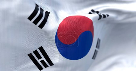 Téléchargez les photos : Close-up view of the South Korea national flag waving. The flag is a white field with a red and blue taegeuk in the center. Fabric textured background. Selective focus. Realistic 3d illustration - en image libre de droit