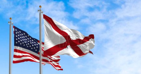 Photo for The flag of the state of Alabama waving alongside the national flag of the United States on a sunny day. The flag of Alabama features a red cross on a white field. Realistic 3d illustration - Royalty Free Image