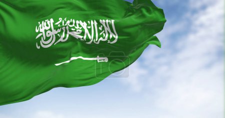 Téléchargez les photos : Saudi Arabia national flag waving in the wind on a clear day. Green field with Shahada and sword in Thuluth script. Rippled fabric. Realistic 3d illustration - en image libre de droit