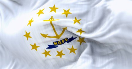 Foto de Close-up of the Rhode Island state flag waving. Gold anchor in the center surrounded by thirteen gold stars. Rippled fabric. Textured background. Selective focus. Realistic 3d illustration - Imagen libre de derechos