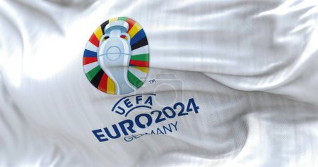 Téléchargez les photos : Berlin, DE, October 2022: UEFA Euro 2024 flag flying. The 17th edition will take place from 14 June to 14 July 2024 in Germany. Selective focus. International sport event. 3D illustration - en image libre de droit