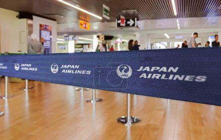 Photo for Tokyo, JP, Jan 2023: Blue belt barrier with white Japan Airlines logo. Japan Airlines is the japanese flag carrier. Travel and airport security - Royalty Free Image