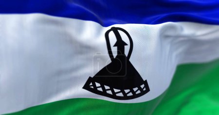 Foto de Detail of the Lesotho national flag waving. Horizontal blue, white, and green with a black mokorotlo in the center. Rippled fabric. Textured background. 3d illustration. Close-up. Selective focus - Imagen libre de derechos