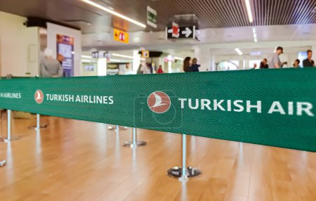 Photo for Istanbul, TR Jan 2023: Green belt barrier with white Turkish Airlines logo. Turkish Airlines is the flag carrier of Turkey. Travel and airport security - Royalty Free Image