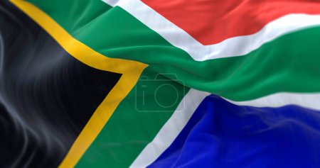 Téléchargez les photos : Détail du drapeau sud-africain agitant. Drapeau rouge et bleu divisé par un Y vert qui entoure un triangle noir avec une bordure jaune. Illustration 3D rendu. Concentration sélective. Gros plan. - en image libre de droit