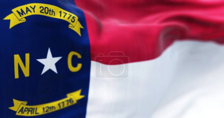 Téléchargez les photos : North Carolina state flag waving. North Carolina is a state in the Southeastern region of the United States. Rippled fabric. 3d illustration render. Selective focus. Close-up. - en image libre de droit