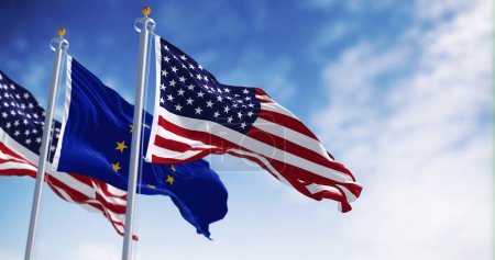 The flags of the United States of America and the European Union waving in the wind on a clear day. 3D illustration render. Rippled fabric. Selective focus. International politics, alliance