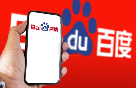 Photo for Beijing, CN, Feb 2023: A hand holding a phone with the Baidu website on the screen. Red background with blurred Baidu logo. Baidu is a Chinese multinational technology company - Royalty Free Image