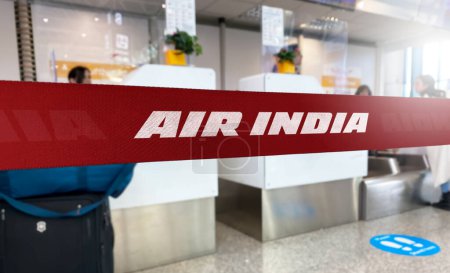 Photo for New Delhi, IN Jan 2023: Red barrier tape with Air India logo inside an airport. Air India is the flag carrier airline of India. Travel and airport security. Illustrative editorial - Royalty Free Image