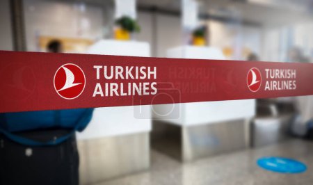 Photo for Istanbul, TR Jan 2023: Red retractable belt barrier with white Turkish Airlines logo. Turkish Airlines is the turkish flag carrier airline. Travel and airport security. Illustrative editorial - Royalty Free Image