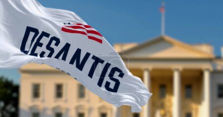 Photo for Washington D.C., US, April 2023: Flag with ron DeSantis 2024 presidential election campaign logo waving in front a blurred White House. Illustrative editorial 3d illustration render - Royalty Free Image