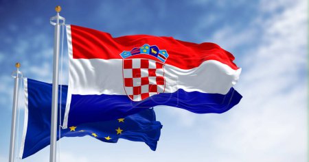The flags of Croatia and the European Union fluttering together on a clear day. Croatia has been a member of the eurozone since January 1, 2023. 3D illustration render. Fluttering fabric