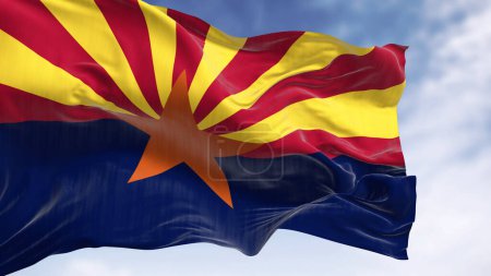Téléchargez les photos : Le drapeau de l'Arizona agitant dans le vent par temps clair. Étoile de cuivre, 13 rayons rouges et jaunes, et une moitié inférieure bleue. Illustration 3D rendu. Concentration sélective. Textiles flottants - en image libre de droit