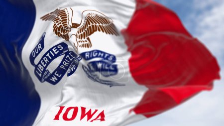 Close-up of the Iowa state flag waving. Three vertical stripes of blue, white, and red, with a bald eagle in the center. 3d illustration render. Textured fabric background. Selective focus