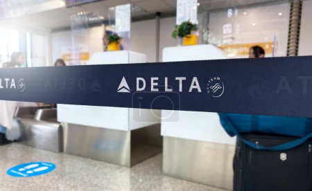 Photo for New York, US May 2023: Blue retractable belt barrier with white Delta Airlines and SkyTeam logos. Major American airline. Travel and airport security. Illustrative editorial - Royalty Free Image