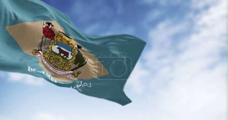 Photo for Delaware state flag waving on a clear day. Colonial blue background with a buff-colored diamond and state coat of arms, and December 7, 1787 below it. 3d illustration render. Fluttering fabric - Royalty Free Image