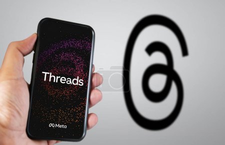 Photo for Menlo Park, US, June 24 2023: hand holding a mobile phone with the Threads application on the screen. Threads is an application developed by Meta to compete with Twitter. Illustrative editorial - Royalty Free Image