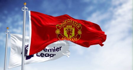 Photo for Manchester, UK, July 2 2023: Manchester United Football Club and Premier League flags waving on a clear day. Premier League pro team. Illustrative editorial 3d illustration render. Selective focus - Royalty Free Image