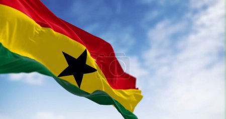 National flag of Ghana waving on a clear day. Three equal horizontal stripes, red, yellow with black star, green, pan-African colors. 3d illustration render. Fluttering fabric. Selective focus