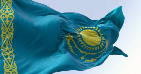 Téléchargez les photos : Gros plan sur le drapeau national du Kazakhstan agitant un jour clair. Champ bleu clair avec un soleil jaune et un aigle volant au centre et une bande ornementale jaune. Illustration 3D rendu. Tissu ondulant - en image libre de droit