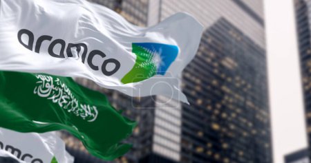Photo for Dhahran, SA, Oct 20 2023: Flags of Aramco and Saudi Arabia waving in a financial district. Aramco is the Saudi national hydrocarbon company. Illustrative editorial 3d illustration render - Royalty Free Image