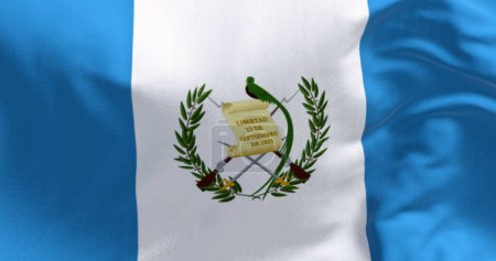 Foto de Primer plano de la bandera nacional guatemalteca ondeando. Tres franjas verticales azul y blanco con un escudo de armas nacional centrado. 3d render ilustración. Tejido ondulado. Texturizado fondo textil - Imagen libre de derechos