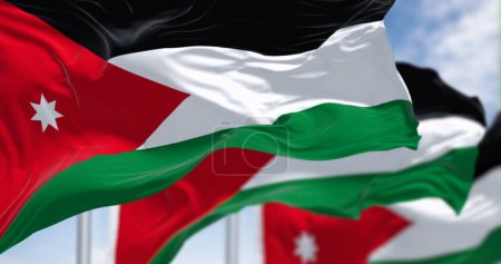 Photo for Jordan national flags waving in the wind on a clear day. Black, white, and green horizontal stripes with a red chevron on the left housing a white seven-pointed star. 3d illustration render. - Royalty Free Image