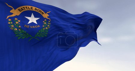 Primer plano de la bandera del estado de Nevada ondeando en el viento en un día despejado. Campo azul cobalto con un emblema estatal en la parte superior izquierda. 3d render ilustración. Tejido ondulado