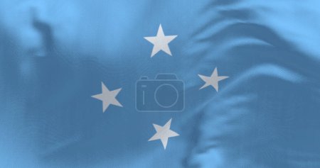 Bandera nacional de los estados federados de Micronesia ondeando en el viento en un día claro. Estado independiente ubicado en el Océano Pacífico. 3d render ilustración. Enfoque selectivo