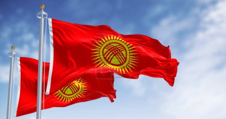 Kyrgyzstan national flags waving on a clear day. Red field, yellow sun with 40 rays, crossed triple laths symbolizing Kyrgyz yurt. 3d illustration render. Rippling fabric
