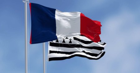 Brittany flag waving with french national flag on a clear day. Brittany is a peninsula, historical country, and cultural area in the west of France. 3d illustration render. Selective focus.