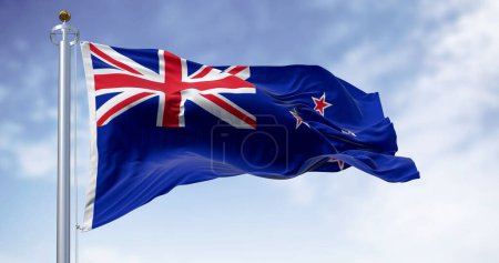 Téléchargez les photos : New Zealand national flag waving on a clear day. Blue Ensign with Union Jack and red stars on representing Southern Cross. Rippled fabric. Realistic 3D illustration - en image libre de droit
