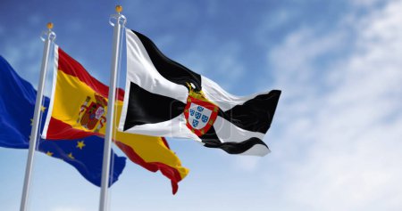 Ceuta und die spanischen Nationalflaggen wehen an einem klaren Tag. Autonome spanische Stadt. Schwarz-weißer Kreisel mit zentralem Gemeindewappen. 3D Illustration rendern. Wellenförmiges Gewebe